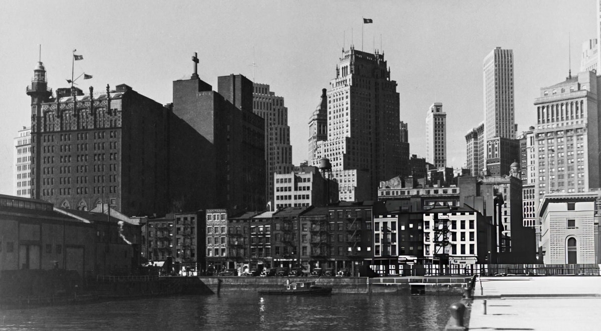 Lower Manhattan Skyline And The First Precinct Police Station Seen From A Pier At Old Slip Over South Street, 1930S.