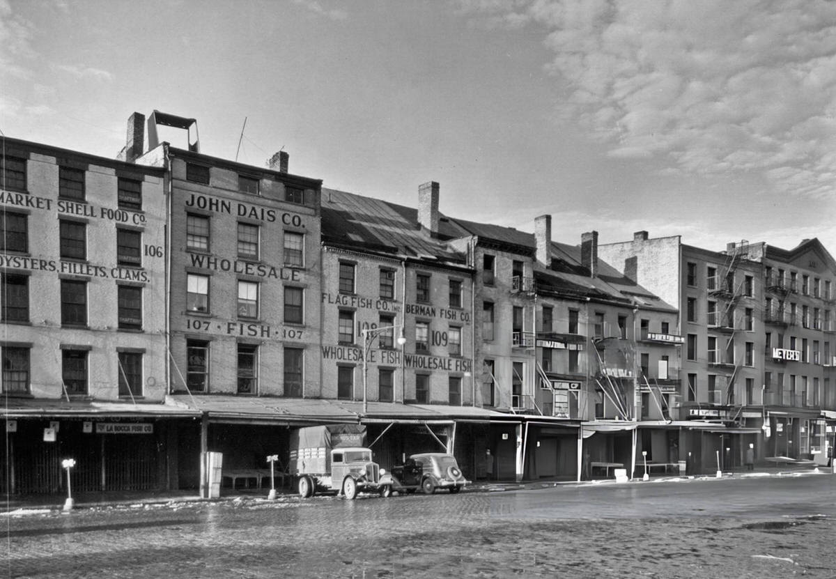 Fish Dealers And The Meyers Hotel On South Street, Manhattan, 1935.