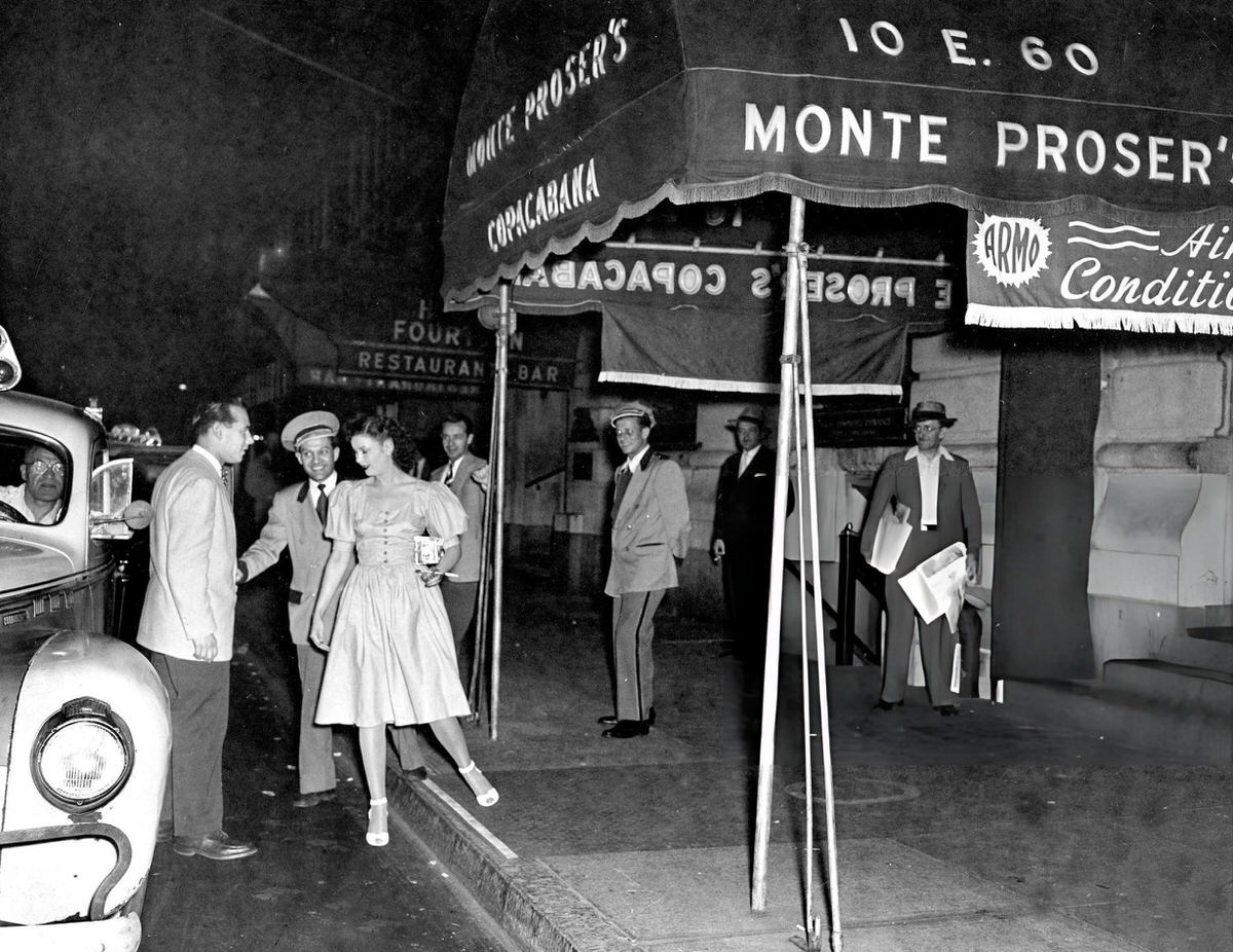 Doorman Harry Schwartz Assisting Patrons Into A Car Outside The Copacabana At 10 East 60Th Street, New York.