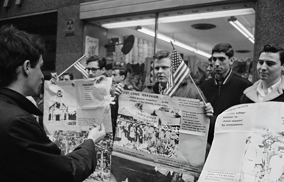 Anti-War Protester Offering A Daffodil To Counter-Protesters At A Peace Rally, New York, 1967.