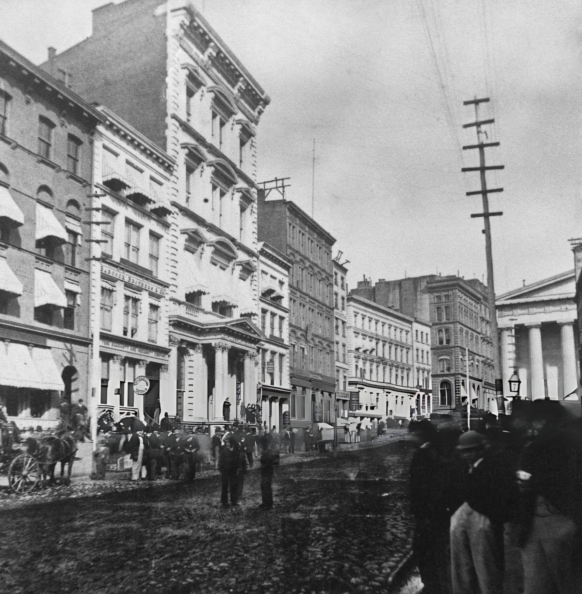 Pedestrians On Broad Street Before The Stock Exchange Building, Lower Manhattan, 1865.