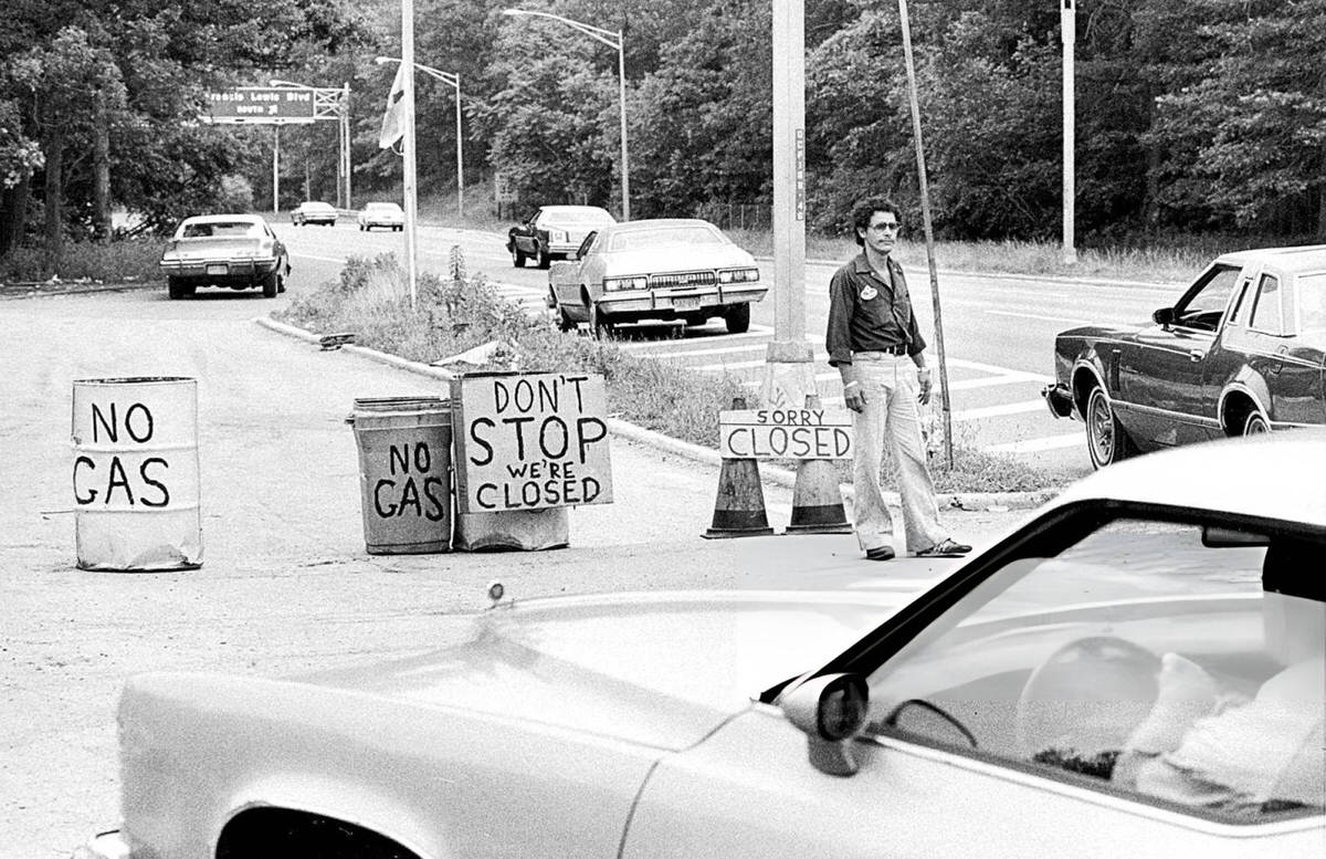 Station Manager George Fernandez Informing Drivers That A Gas Station On Grand Central Parkway Is Closed, Jamaica, 1979.