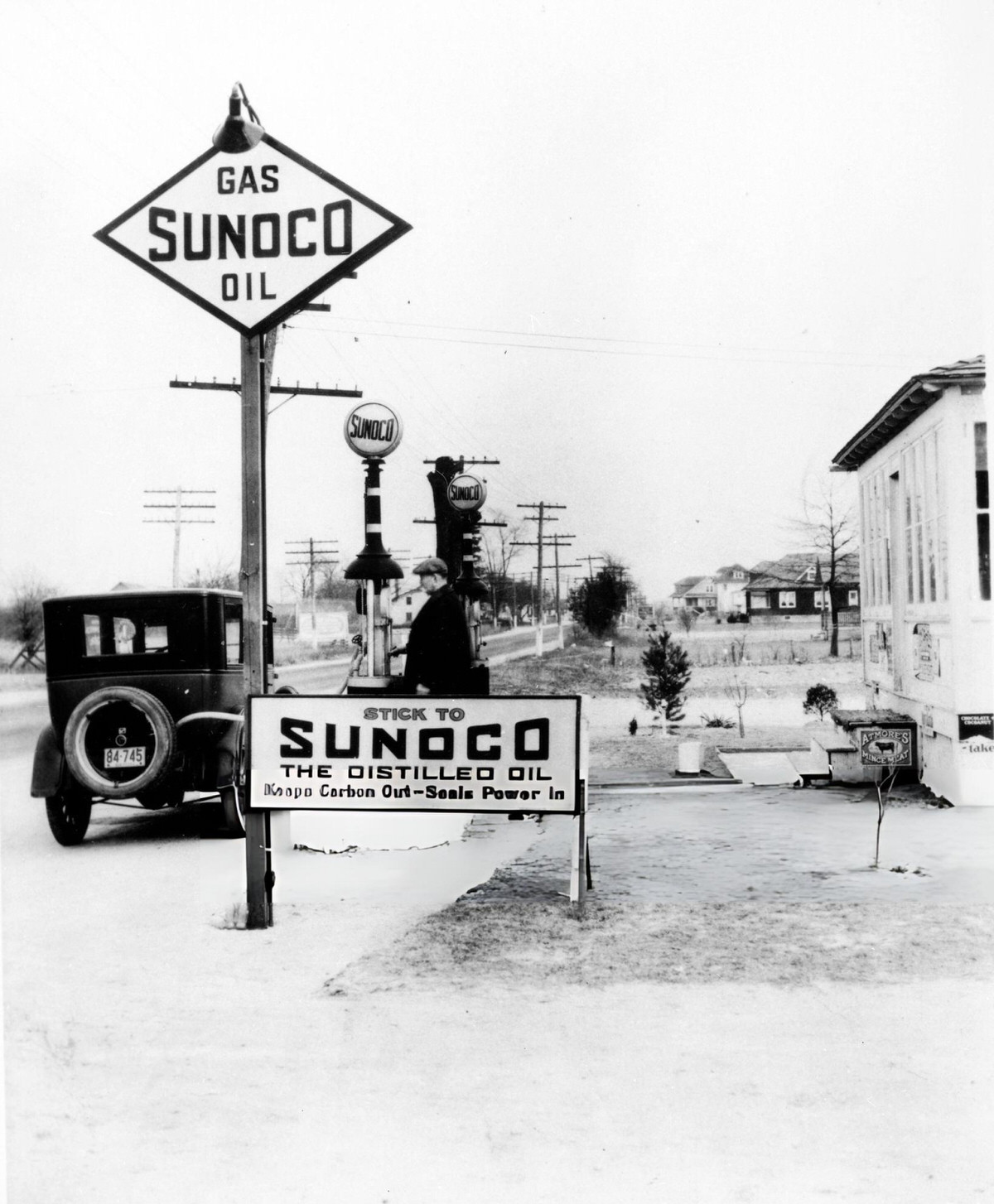 Man Refueling An Automobile At A Sunoco Service Station, New York, 1926.