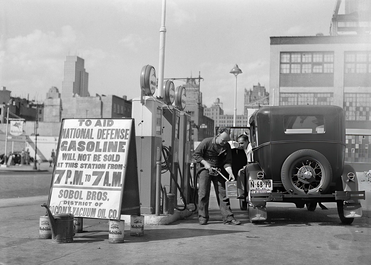 Motorist Filling A Spare Fuel Can Before A Government-Mandated Curfew At A Gas Station, New York, 1941.