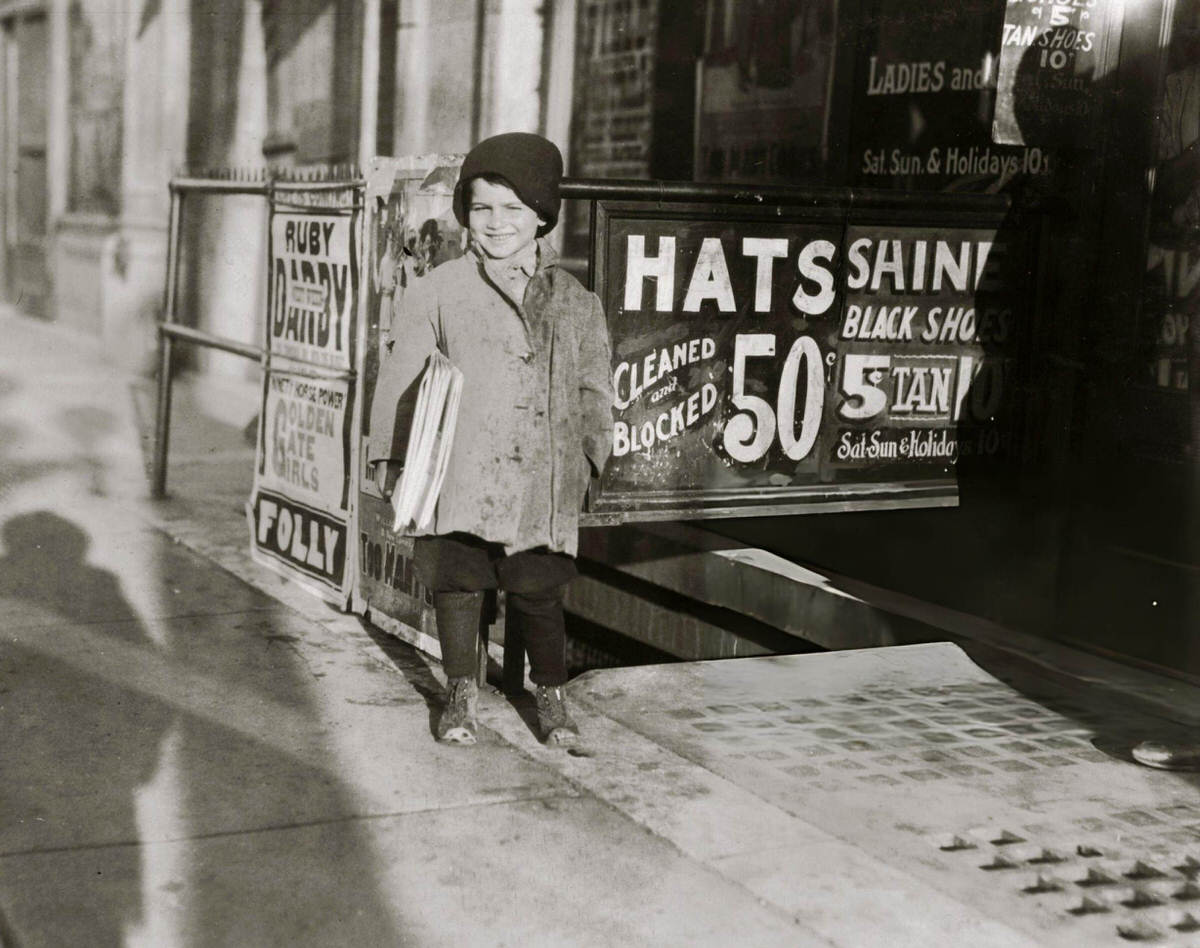 Five-Year-Old Hymie Miller Selling Newspapers On A Sidewalk After School, New York, 1924.