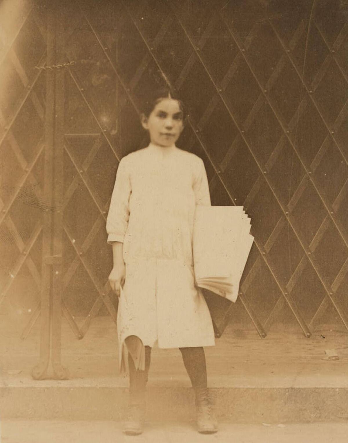 Newsgirl In The Bowery District, New York.