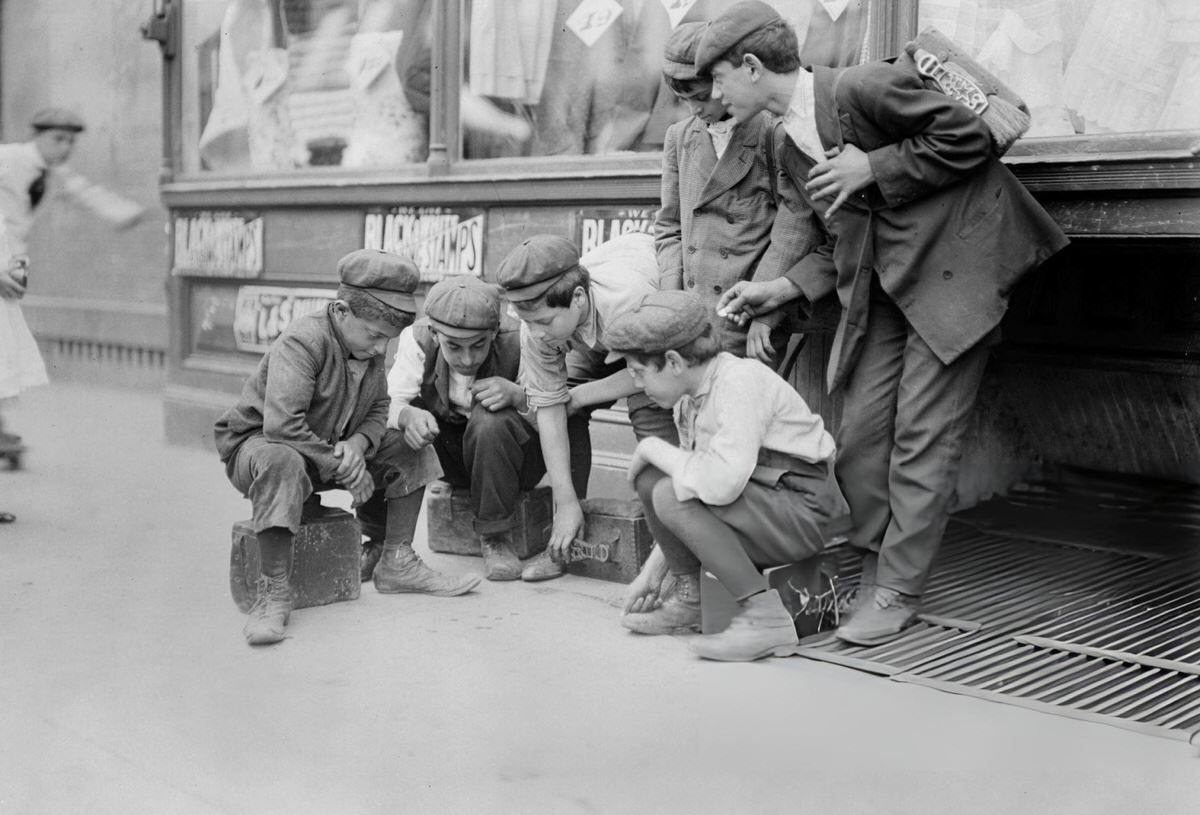 Newsboys And Shoeshine Boys Playing Craps On A Sidewalk, New York, 1910S.