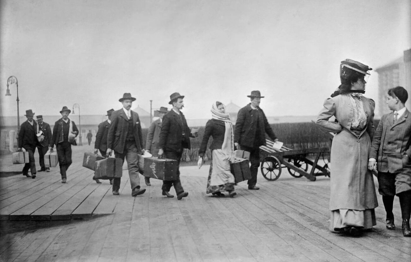 Immigrants Carrying Luggage At Ellis Island, 1910