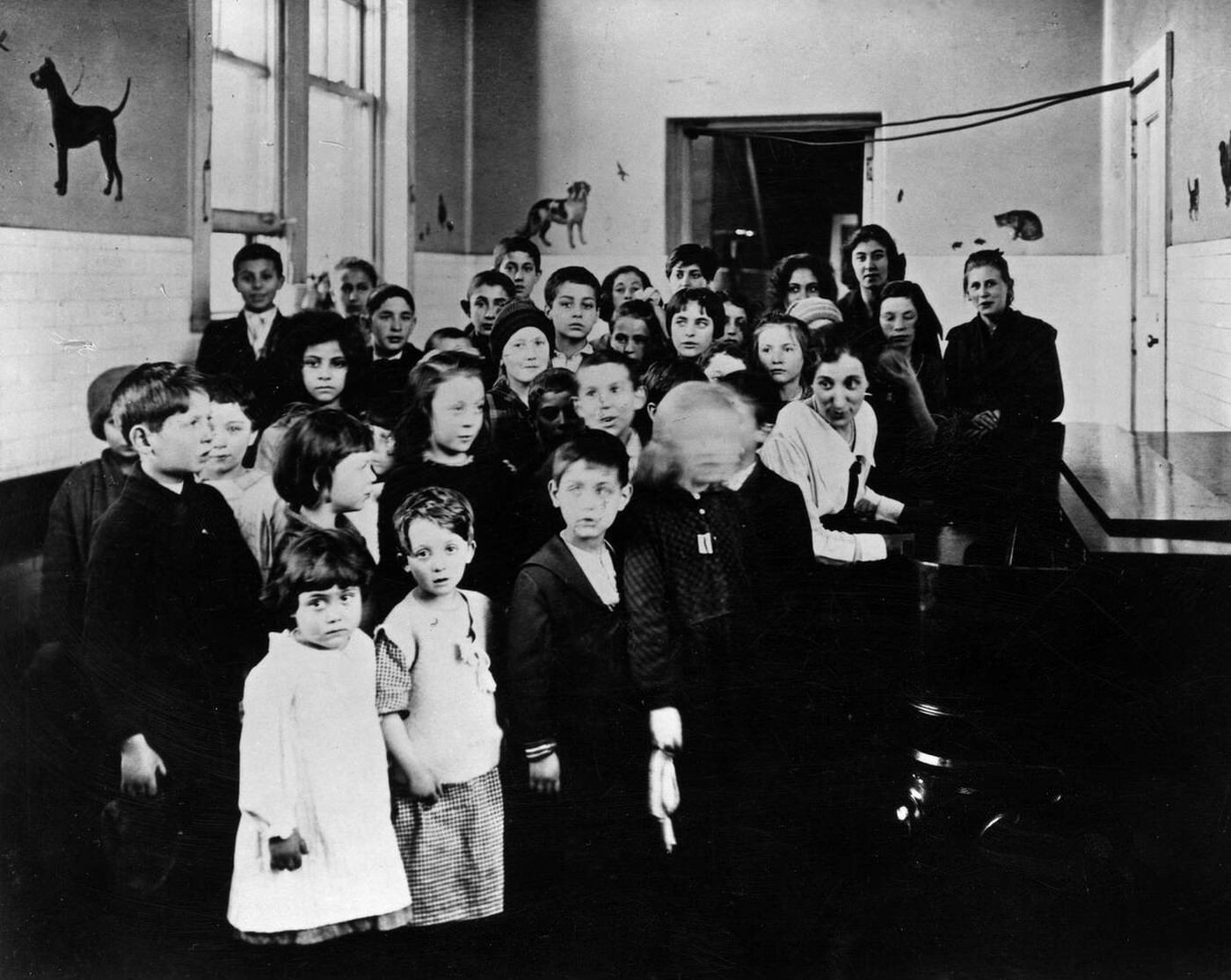 Immigrant Children Learning American Songs In A Classroom At Ellis Island, 1915