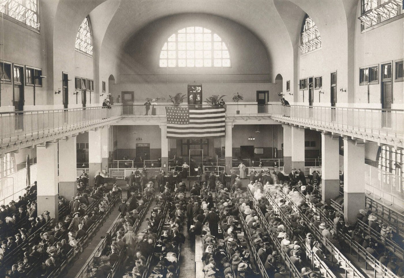 Immigrants Seated On Long Benches In The Main Hall At Ellis Island, 1902