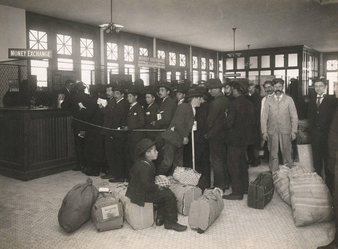 Immigrants With Baggage Lined Up At The Money Exchange Windows At Ellis Island, 1902