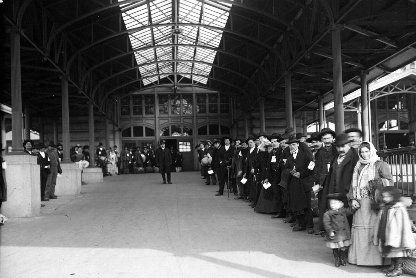 Immigrants Lined Up Outside Waiting To Be Taken Off Ellis Island, 1907