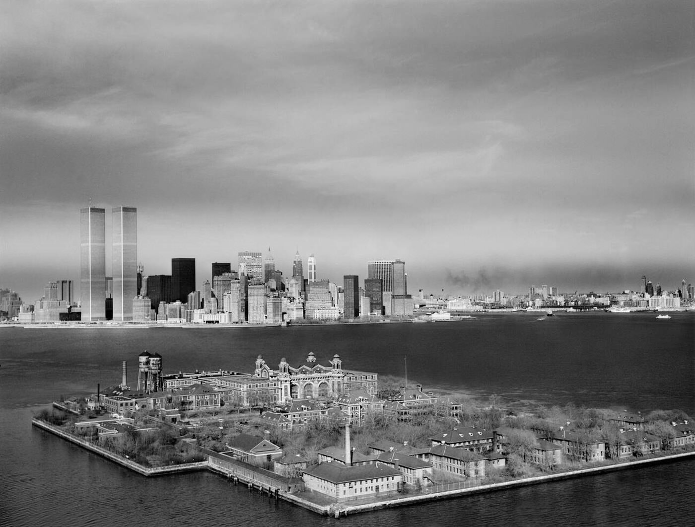Ellis Island With The Manhattan Skyline And World Trade Center In The Background, 1970S